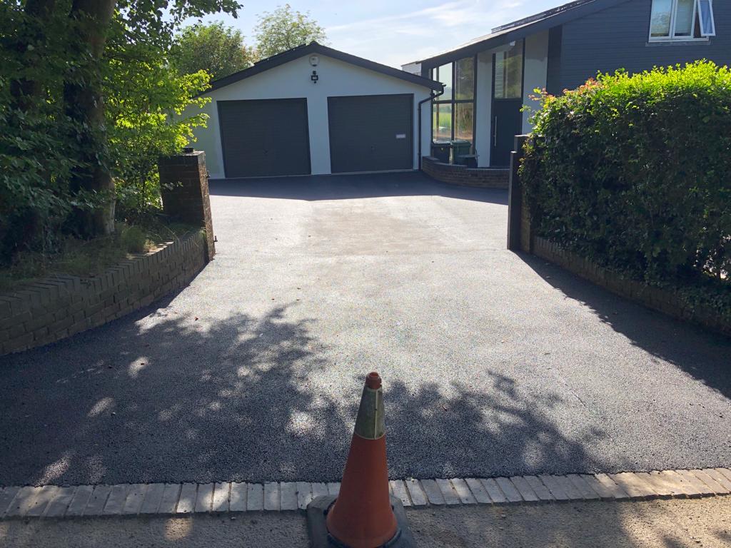 This is a photo of a bitumen driveway which is in the process of being installed by Morayfield Surfacing Solutions