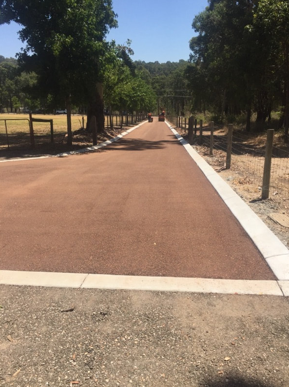 This is a photo of a hot spray & seal bitumen roadway which is in the process of being installed by Morayfield Surfacing Solutions